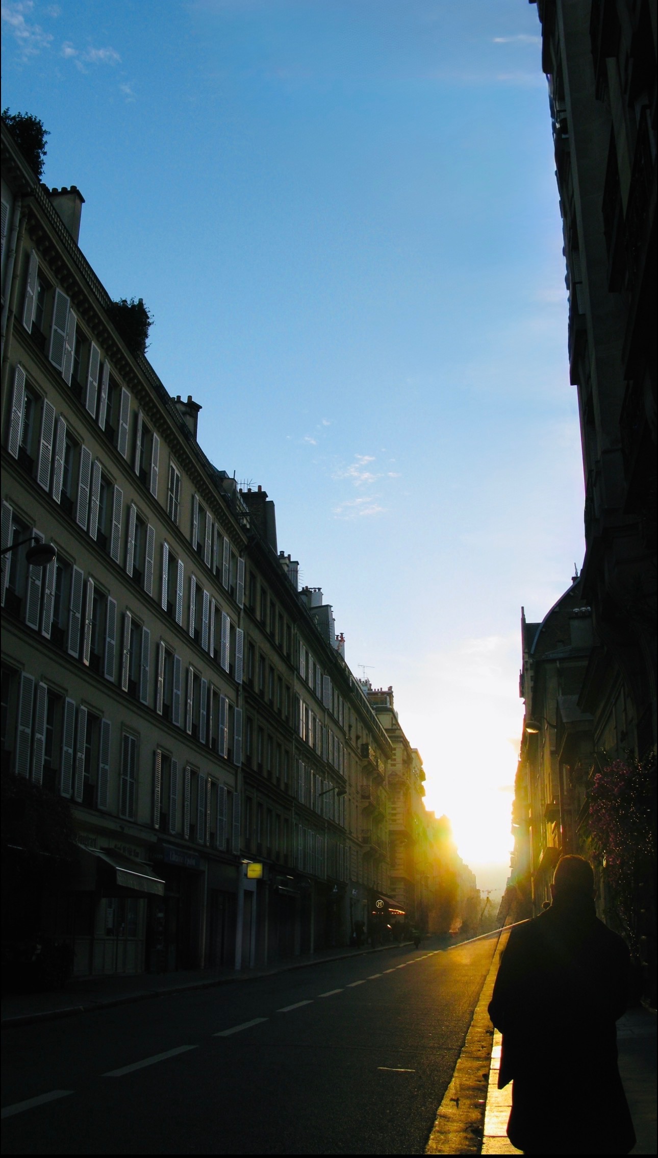 Paris street at sunrise, lone figure