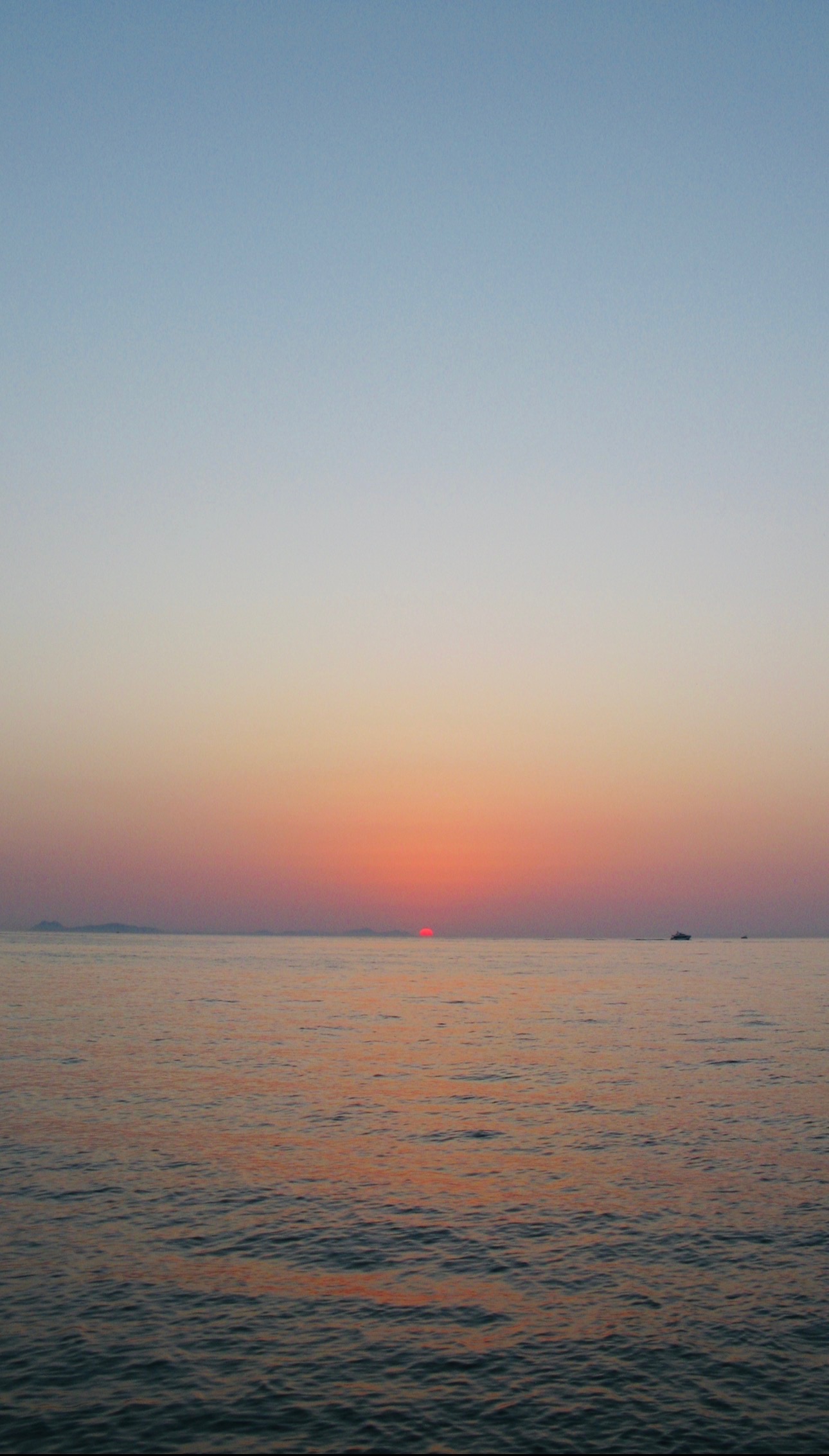 Sea at dusk, distant islands